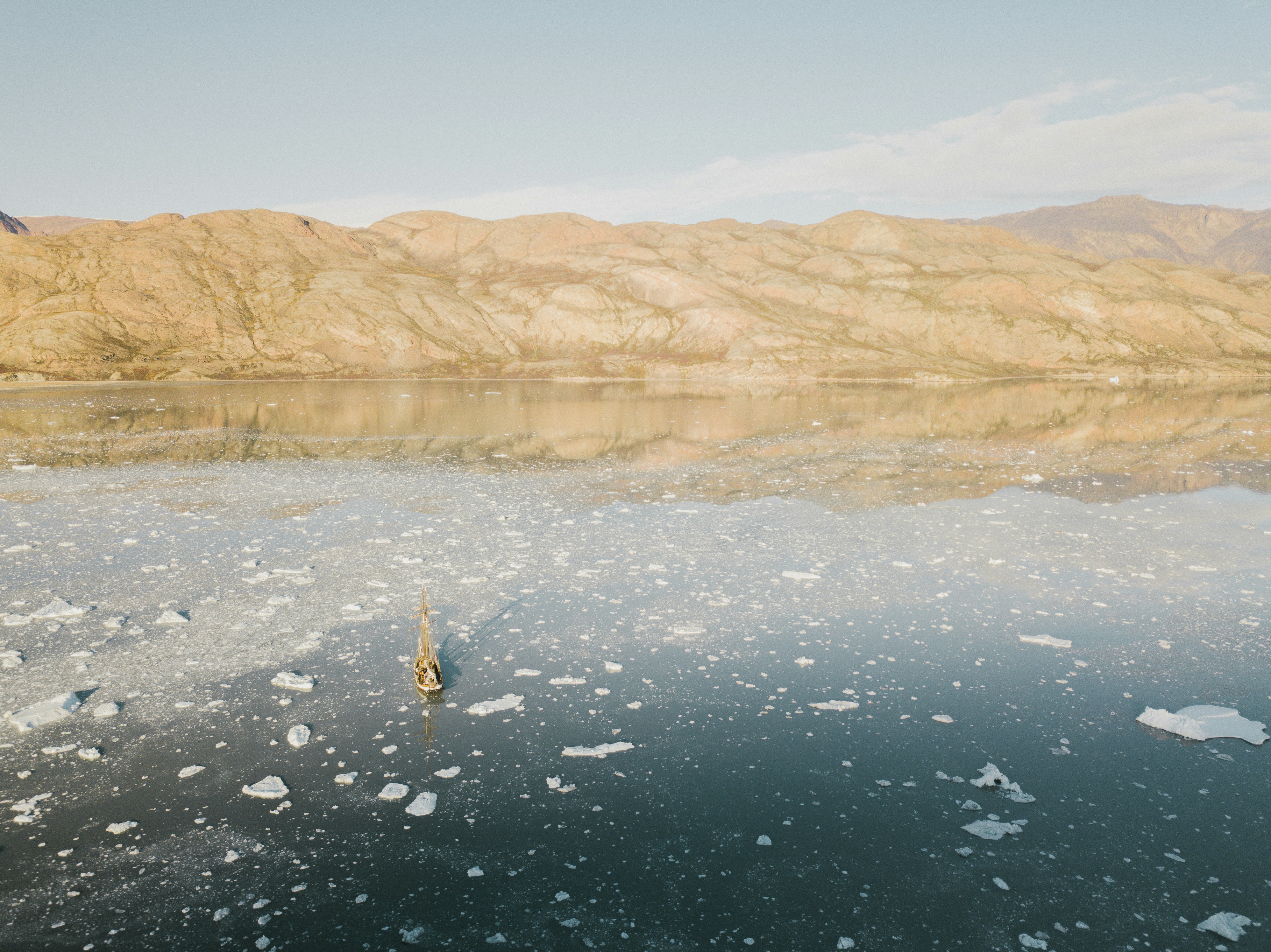 a body of water surrounded by mountains and ice