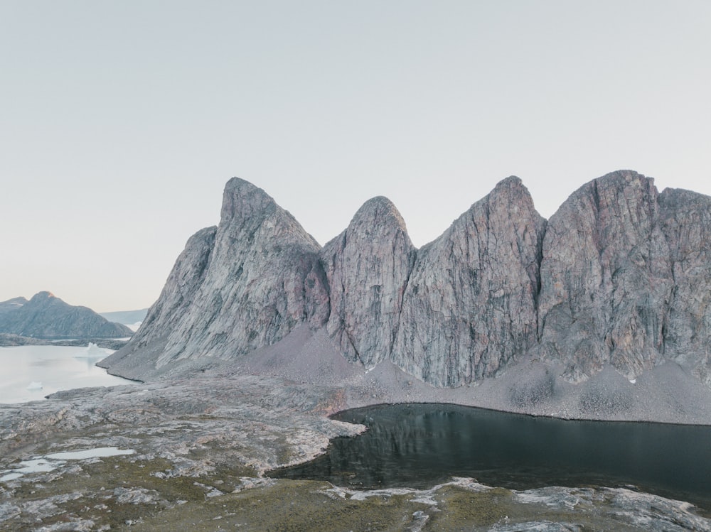 a mountain range with a lake in the foreground