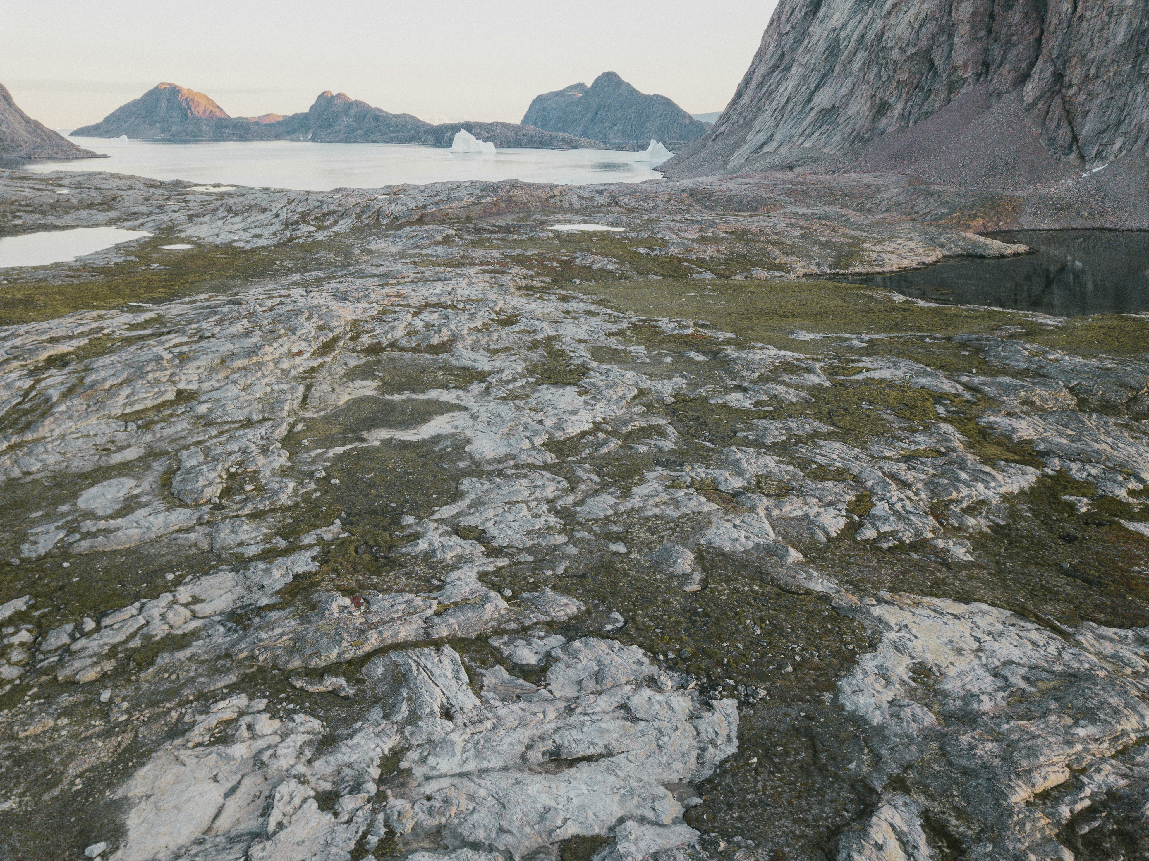 a rocky landscape with a body of water in the distance