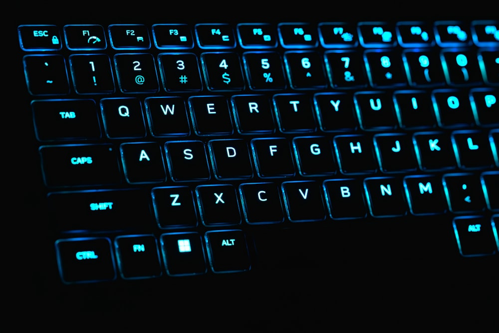 a close up of a keyboard with blue lights
