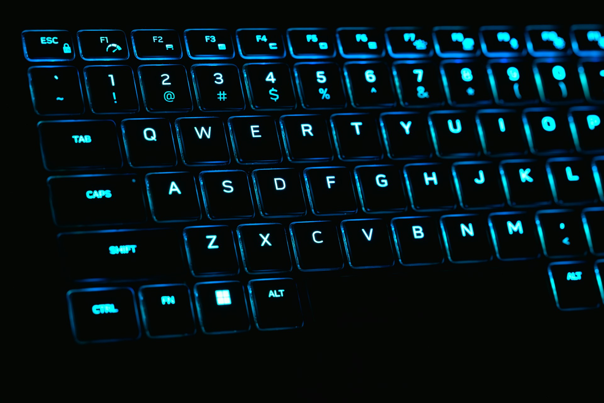 a close up of a keyboard with blue lights