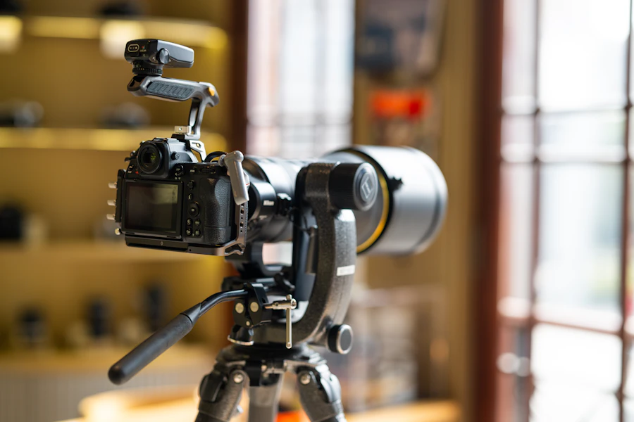 A cinema camera on a tripod indoors
