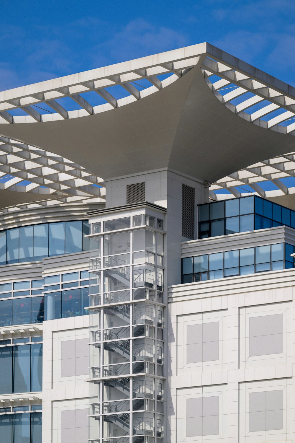 a tall white building with a sky background