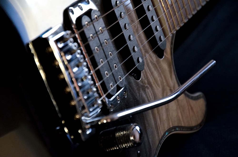 a close up of an electric guitar with a black body