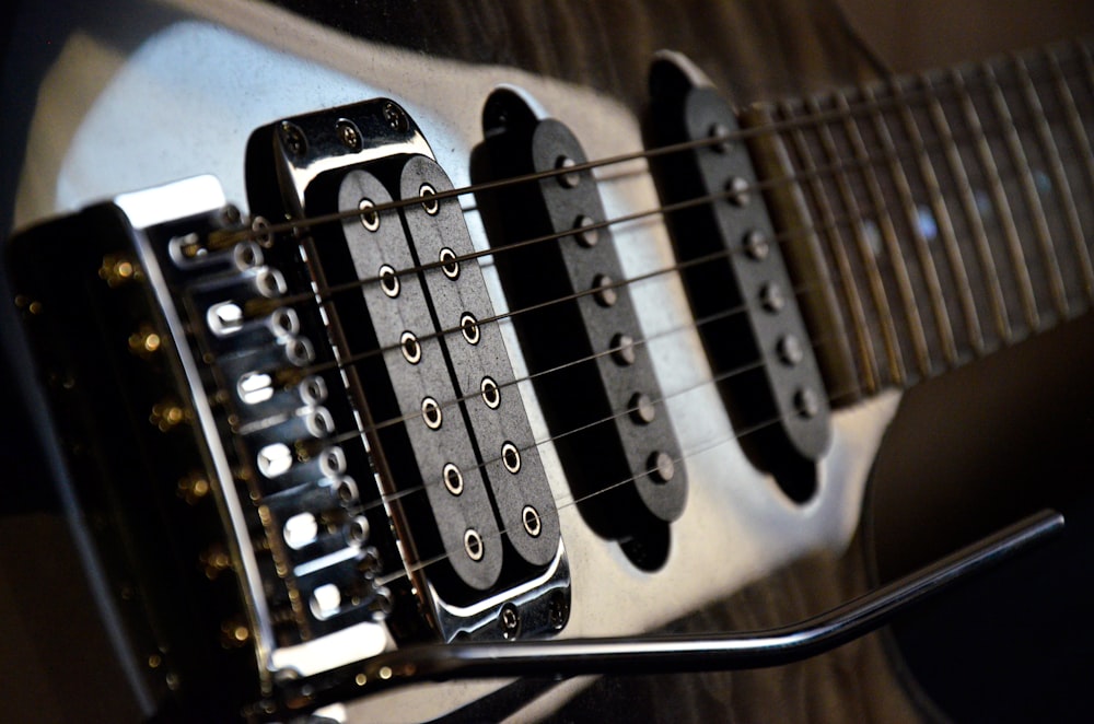 a close up of a black and white guitar