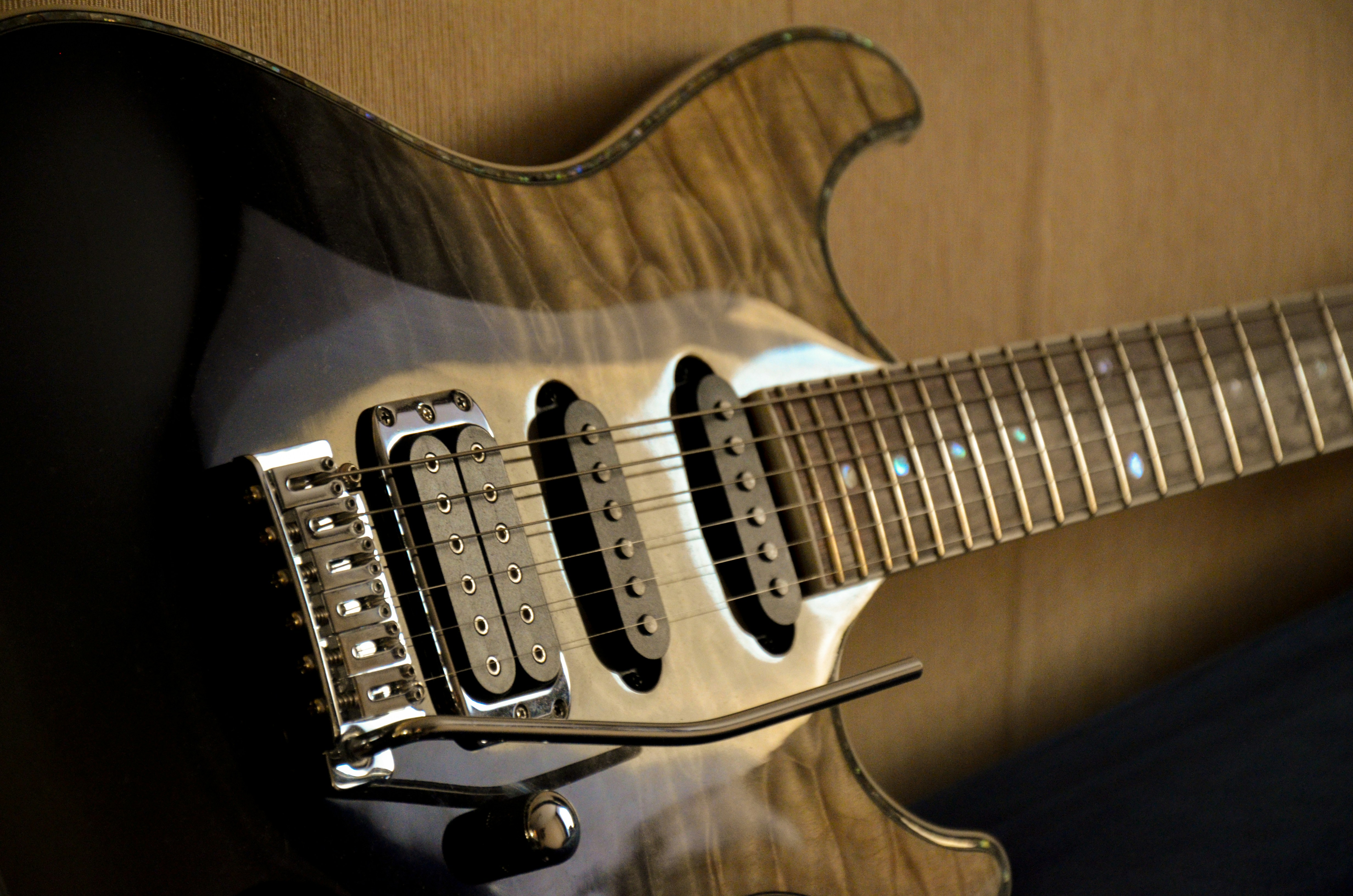 a close up of a guitar on a wall