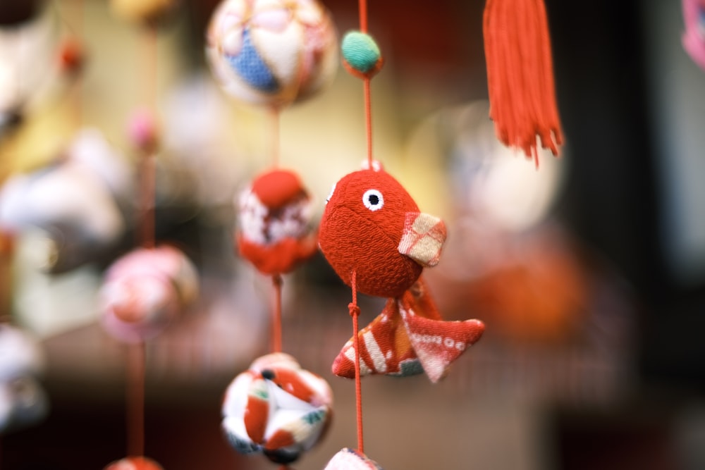a close up of a mobile with balls and a fish