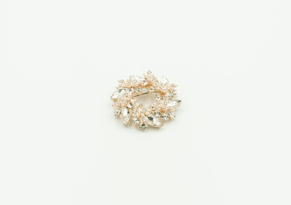 a brooch that is on a white surface