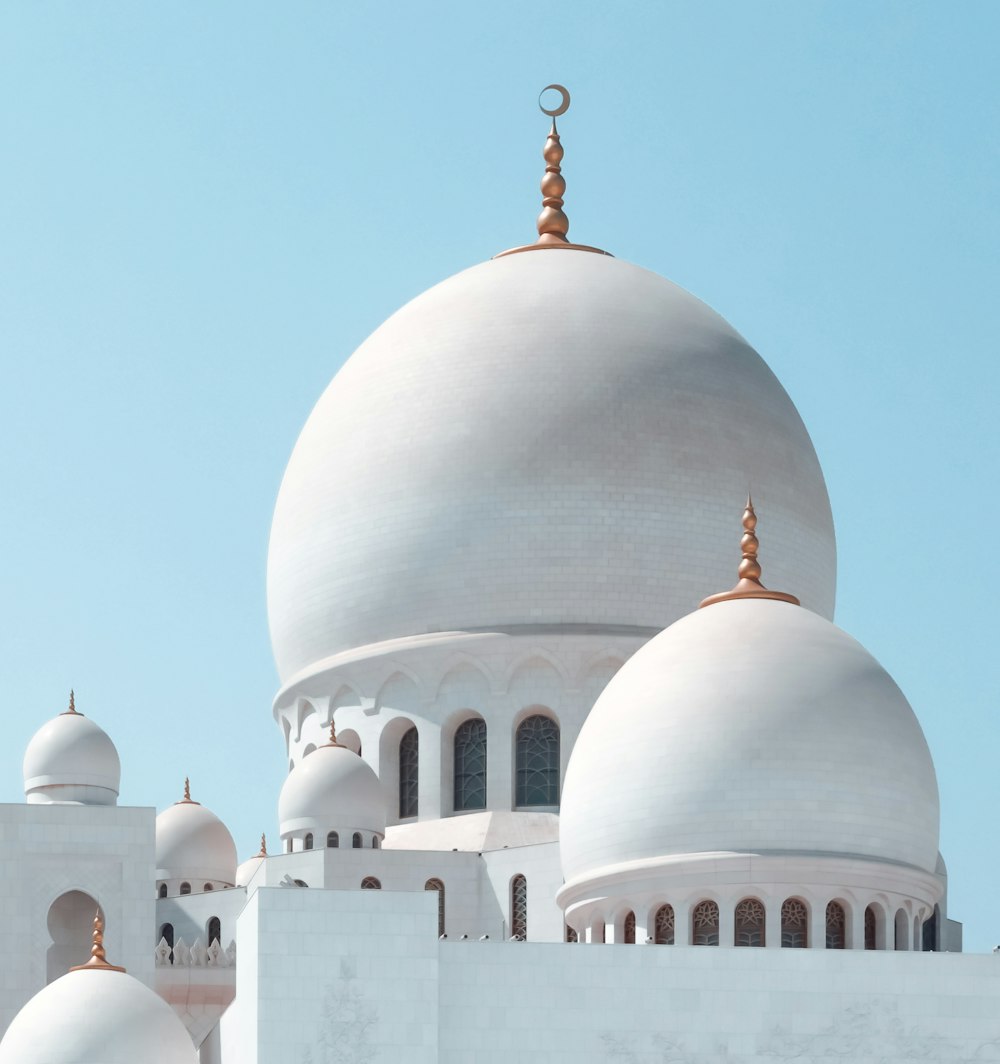 a large white building with two domes on top of it