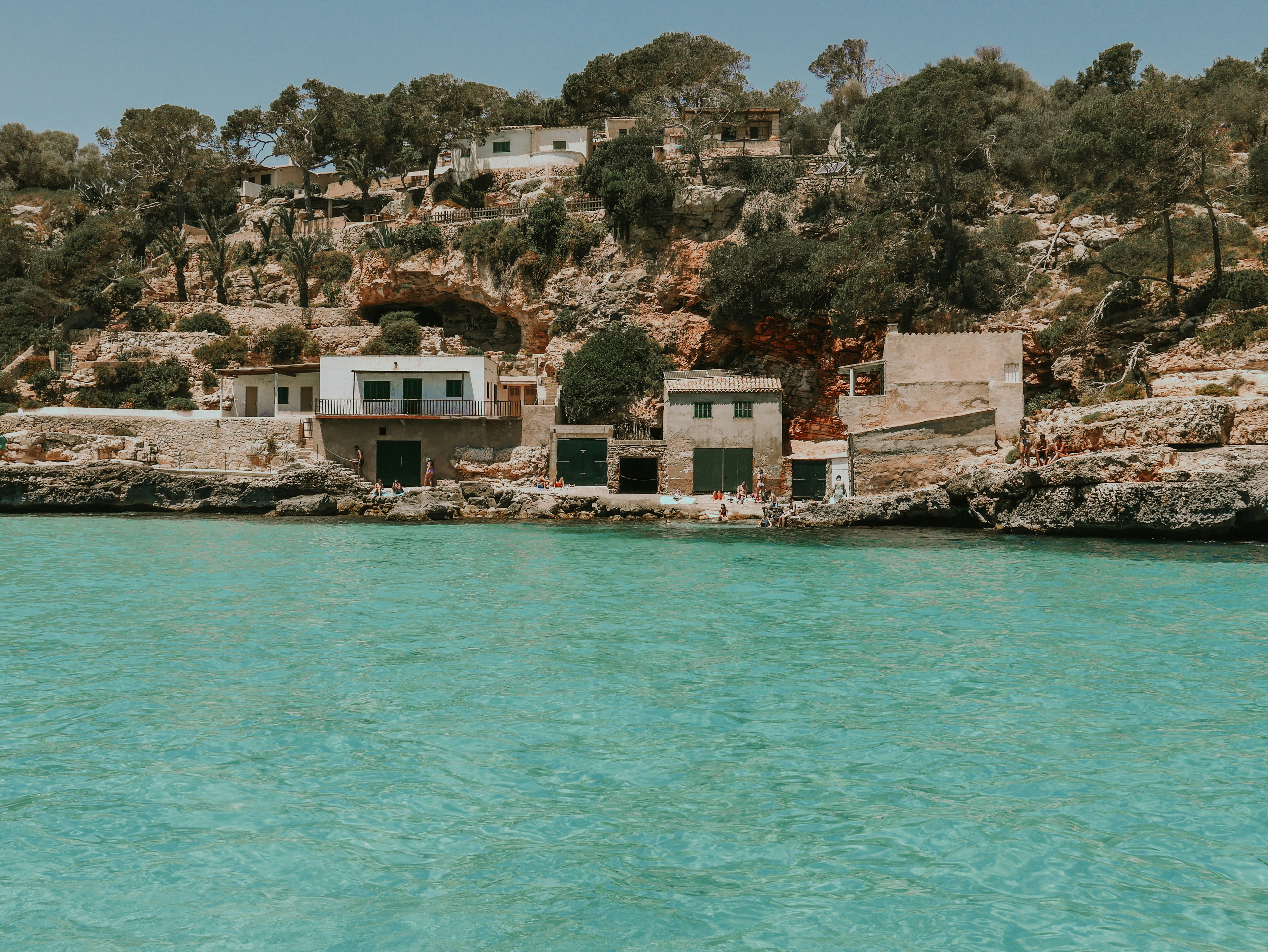a house on a cliff overlooking a body of water
