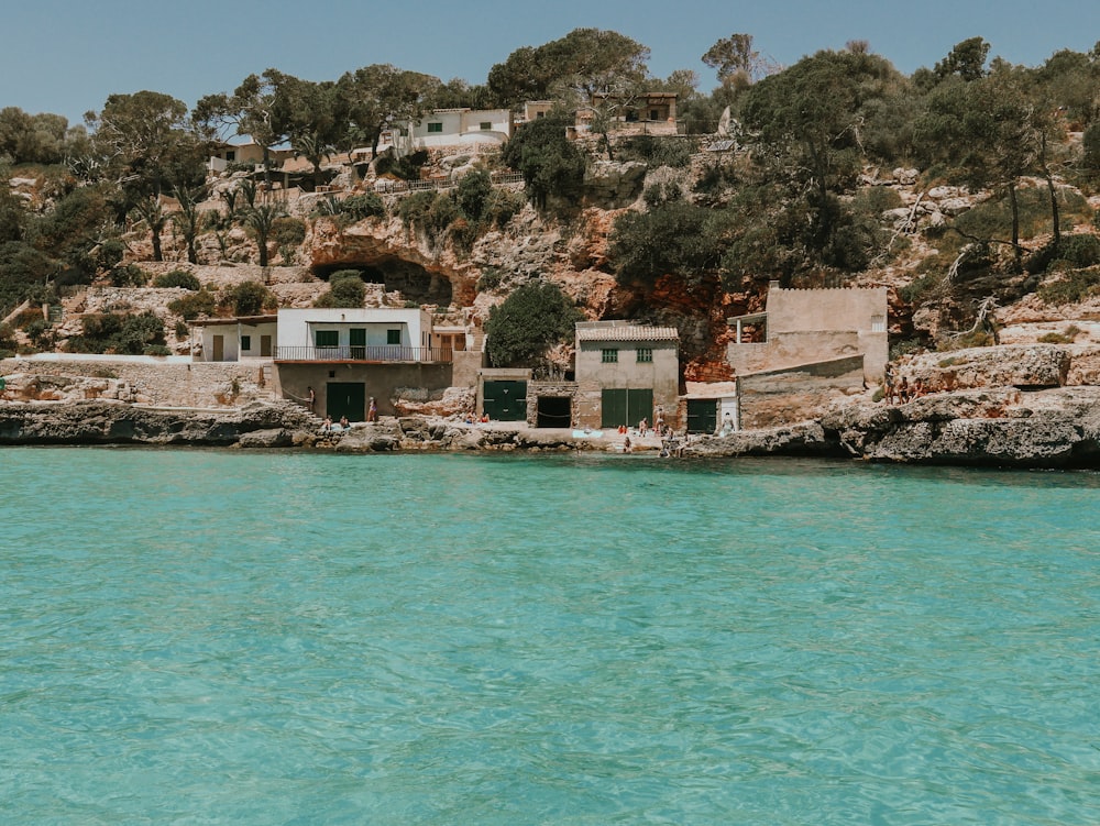 a house on a cliff overlooking a body of water