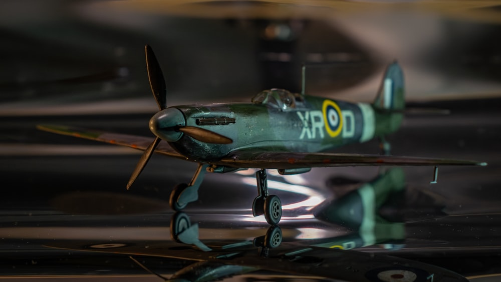 a small green airplane sitting on top of a table