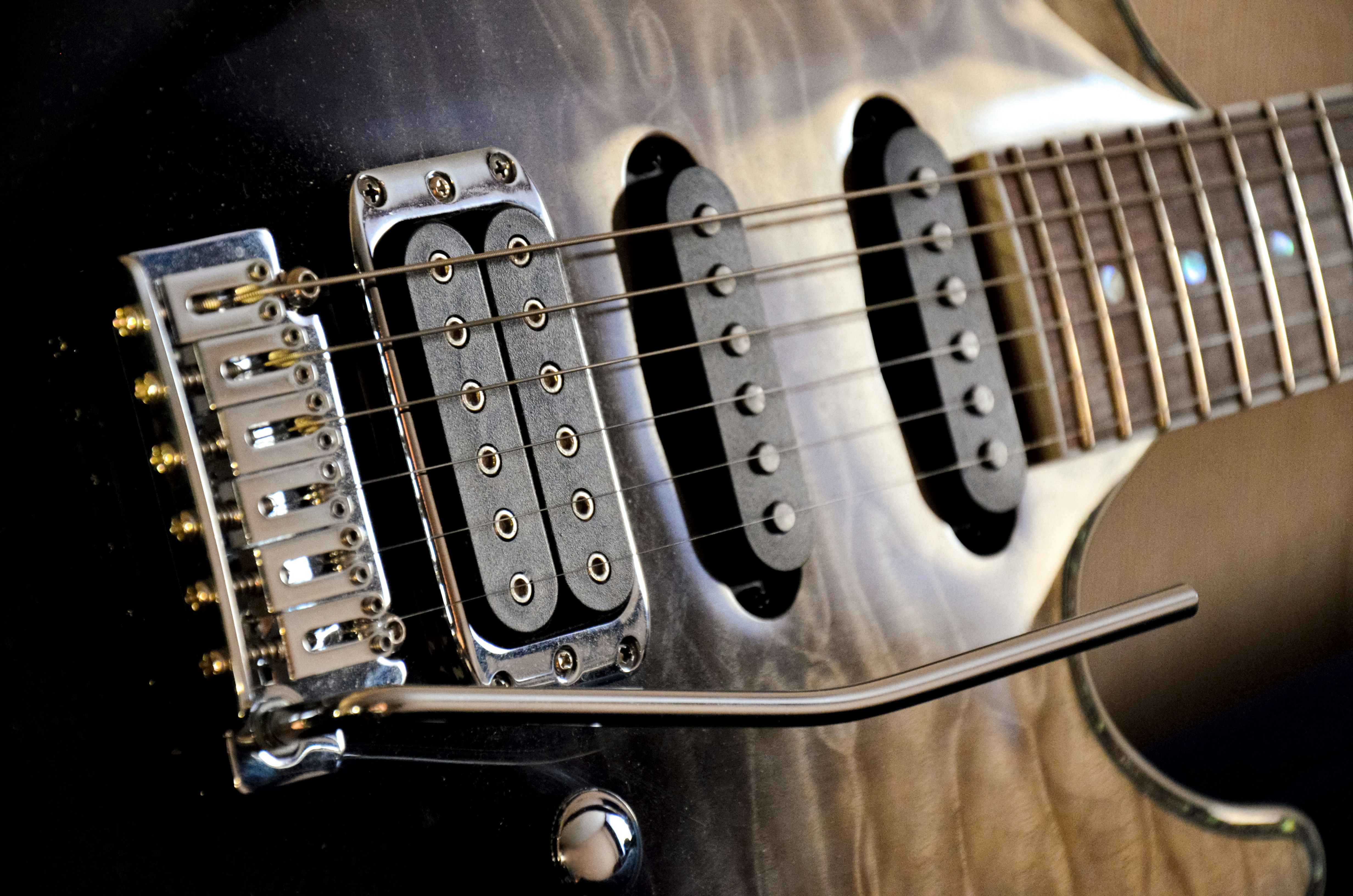 a close up of a guitar neck and strings
