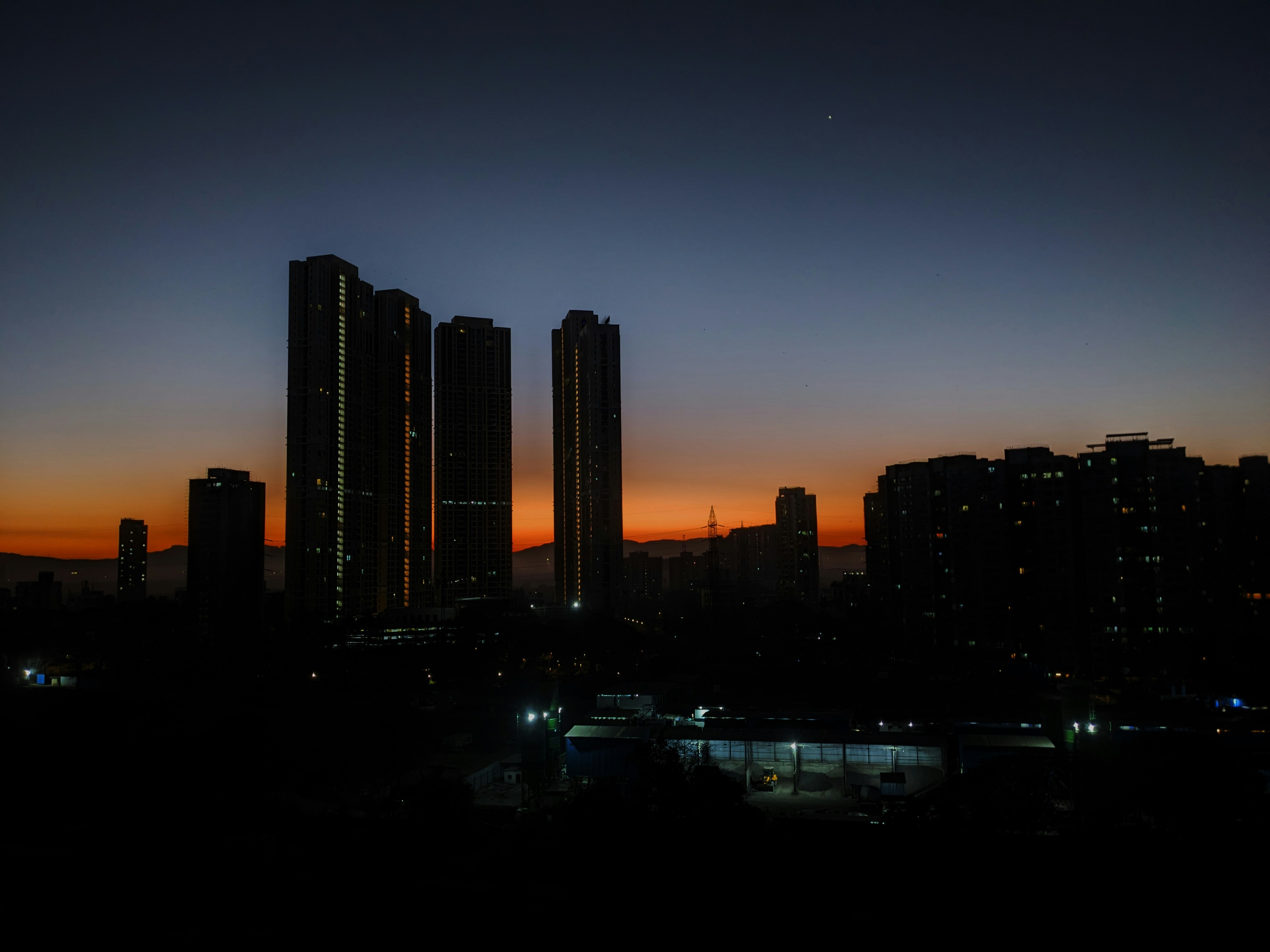 a city skyline with tall buildings at night, Early morning sunrise