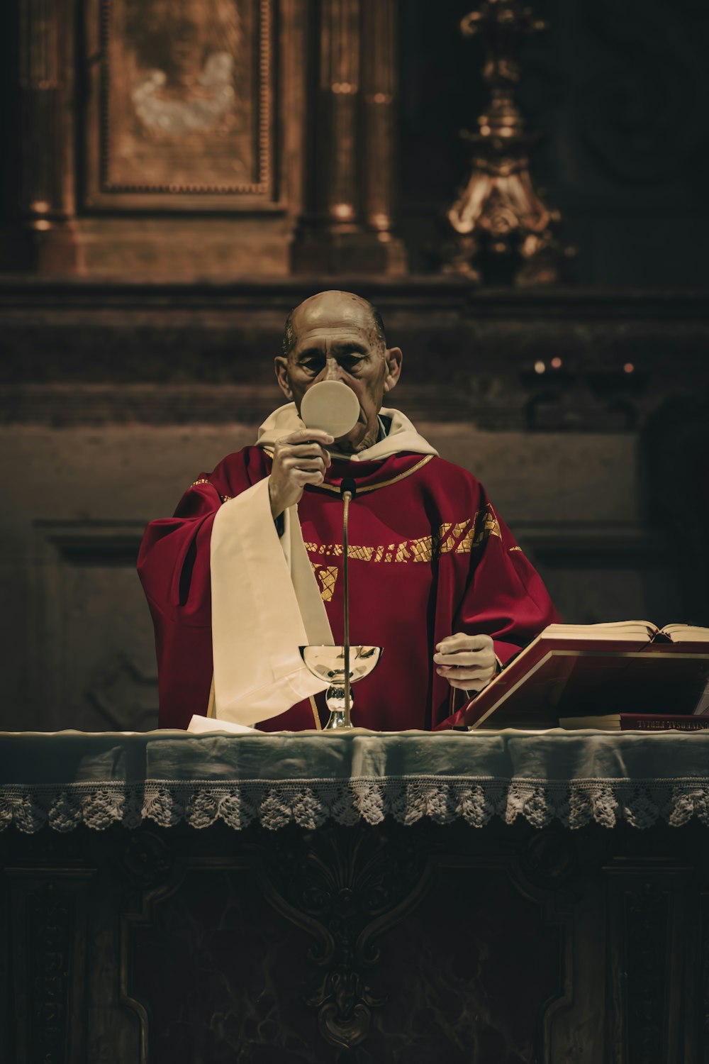 a man in a priest's robes holding a magnifying glass