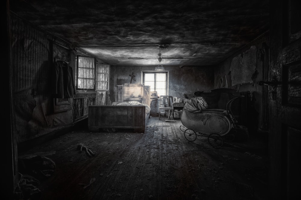 a dark room with a bed and a rocking chair