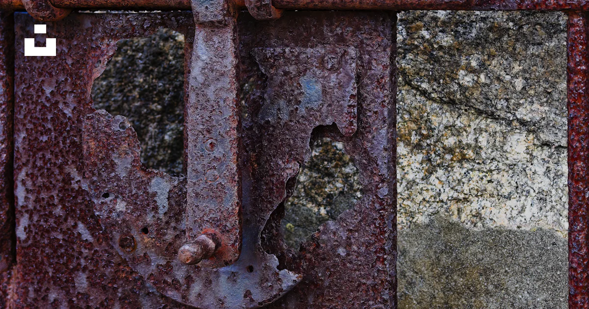 A rusted metal gate with a hole in it photo – Free Castillo de san ...