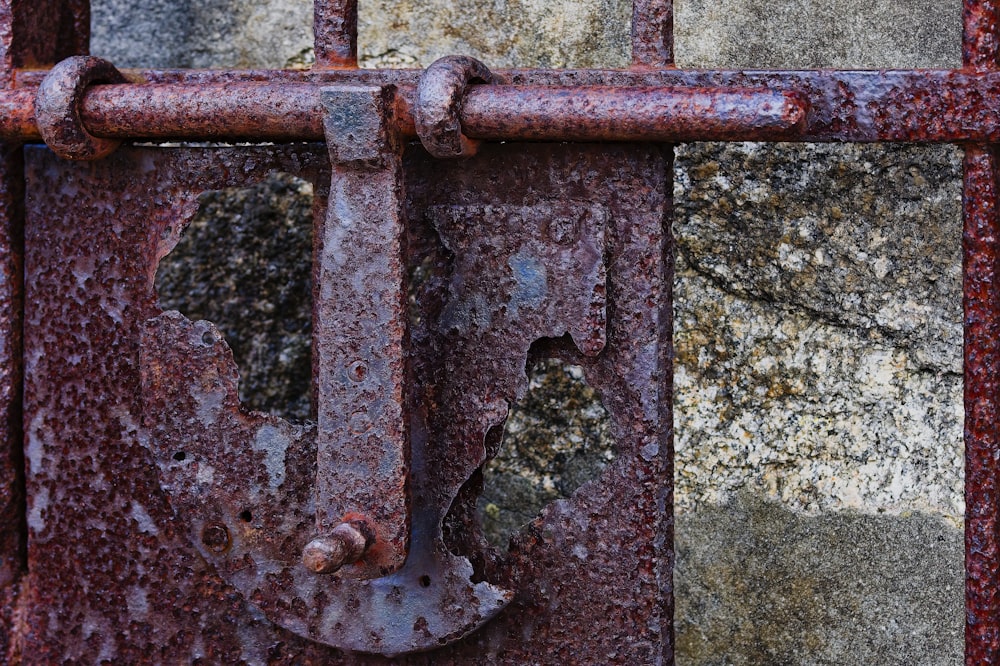 a rusted metal gate with a hole in it