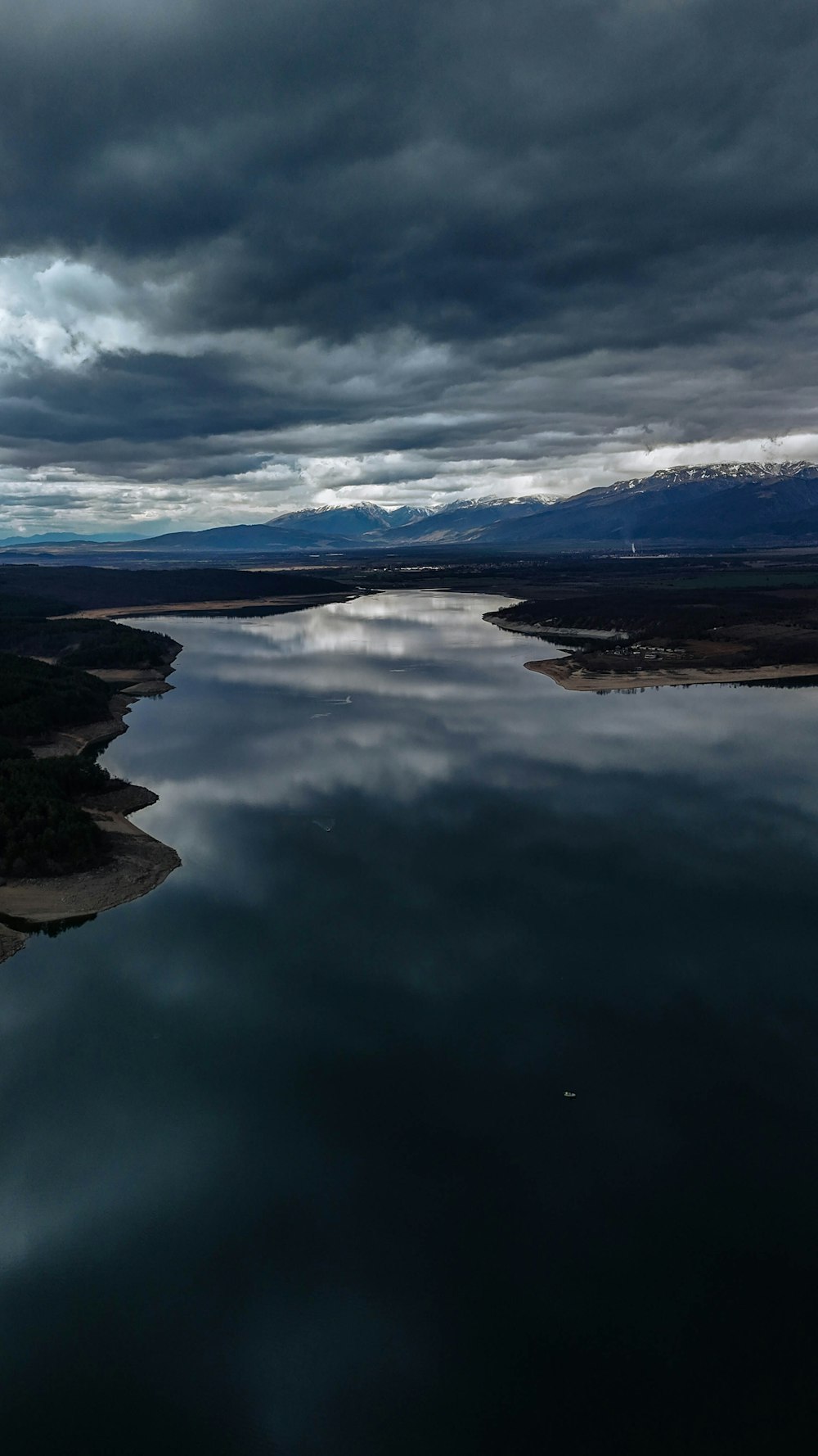 a large body of water under a cloudy sky