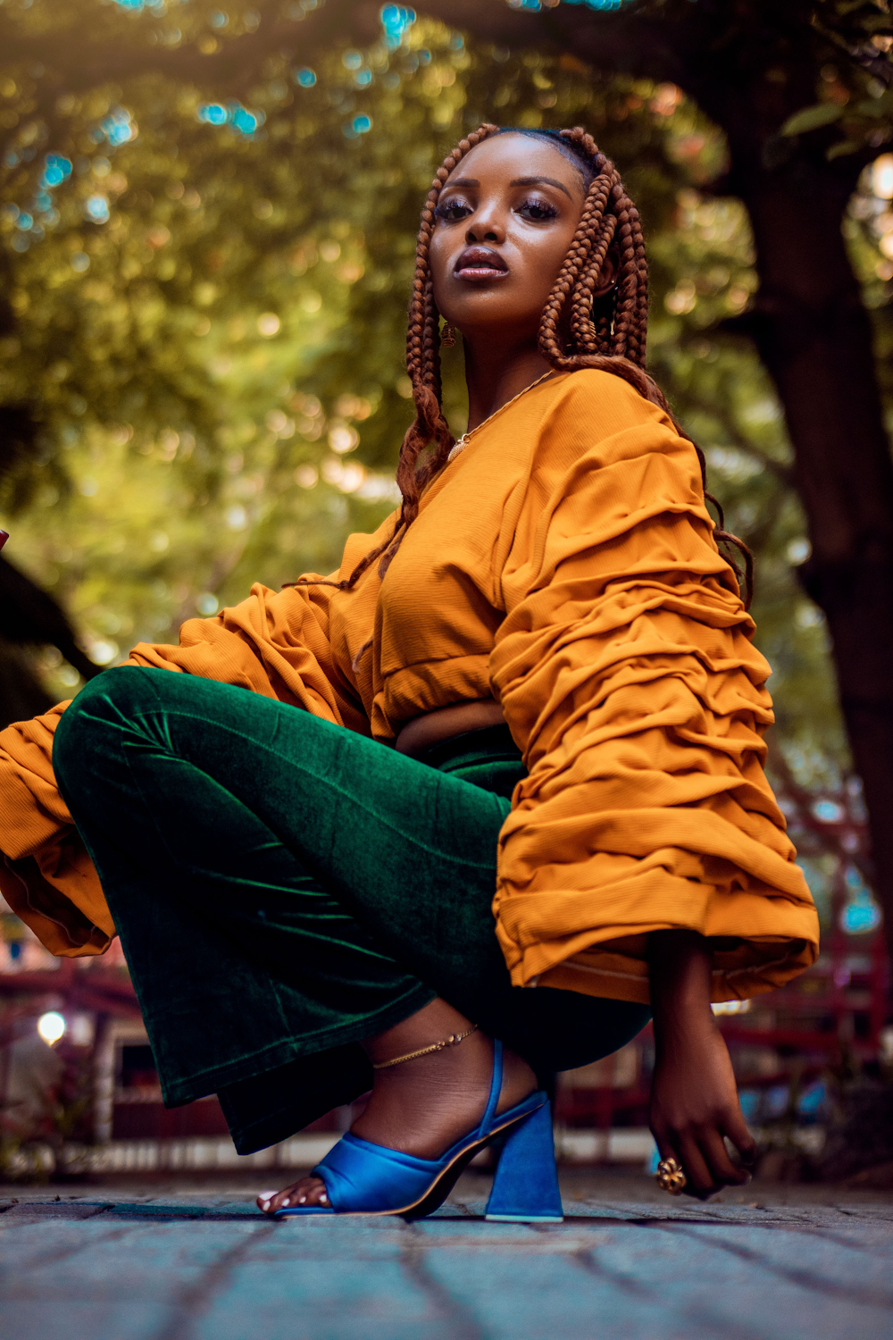 a woman sitting on the ground with her legs crossed