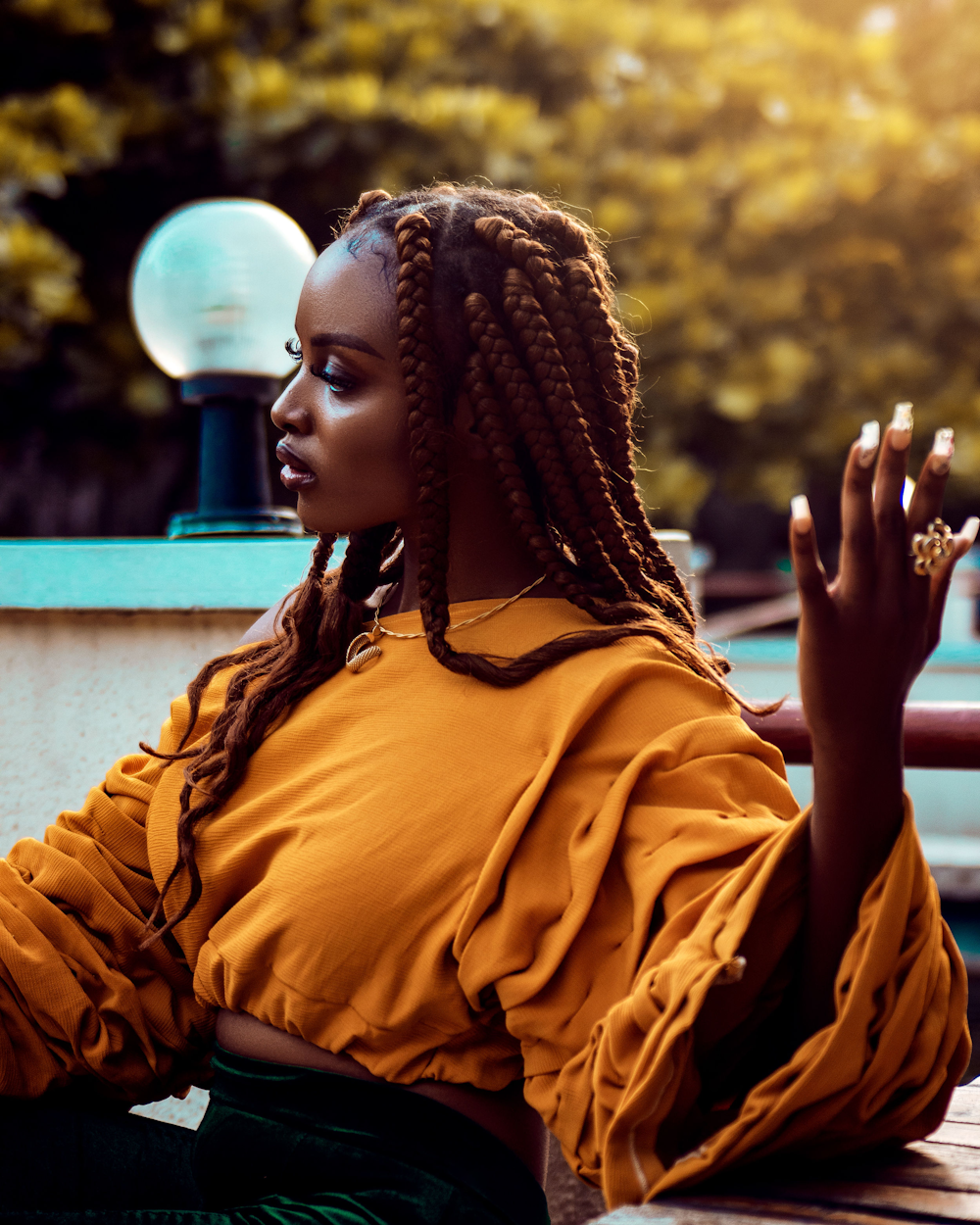 a woman sitting on a bench smoking a cigarette