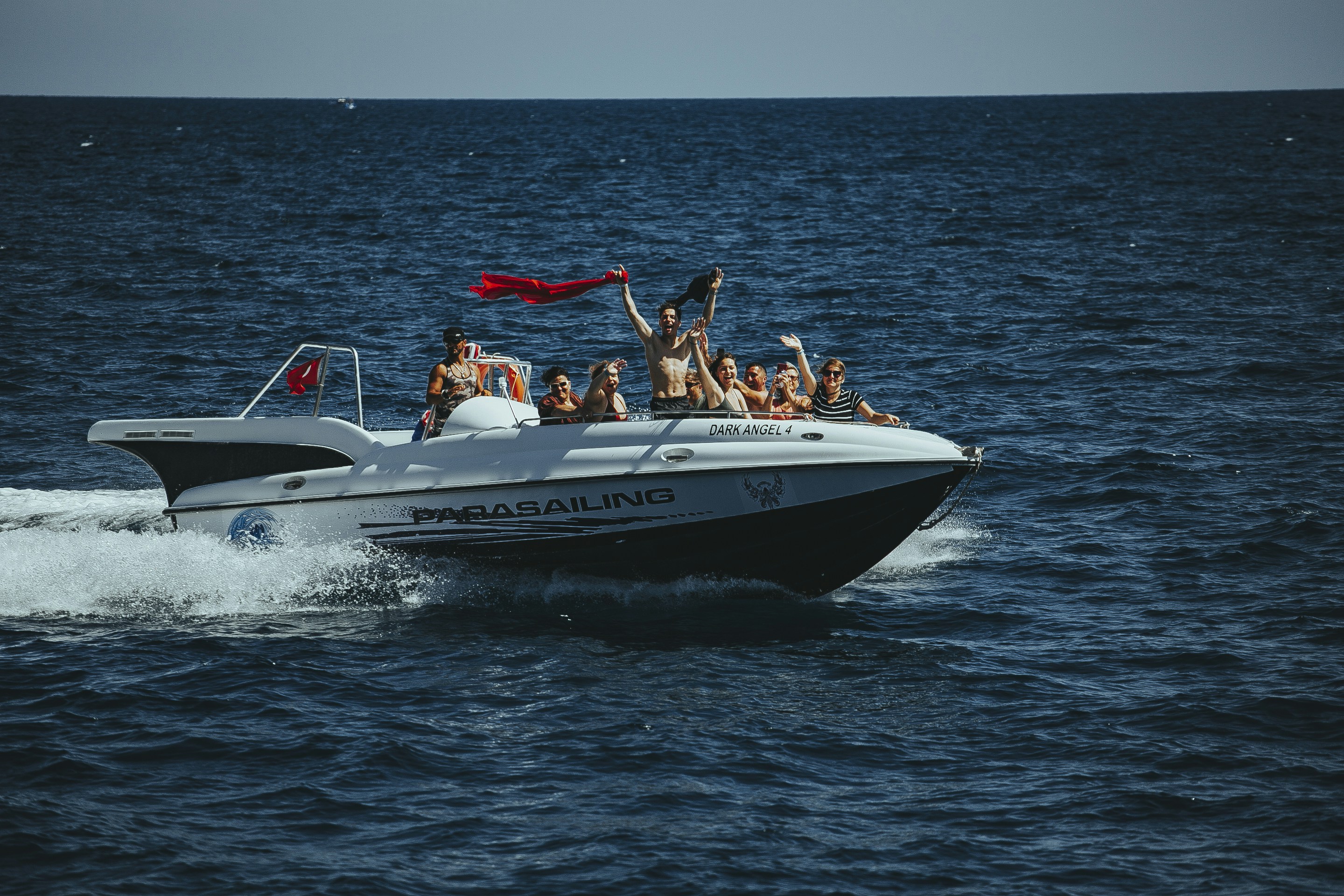 A group of people riding on the back of a boat photo – Free Human Image ...