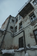 an old building with snow on the ground