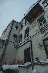 an old building with snow on the ground