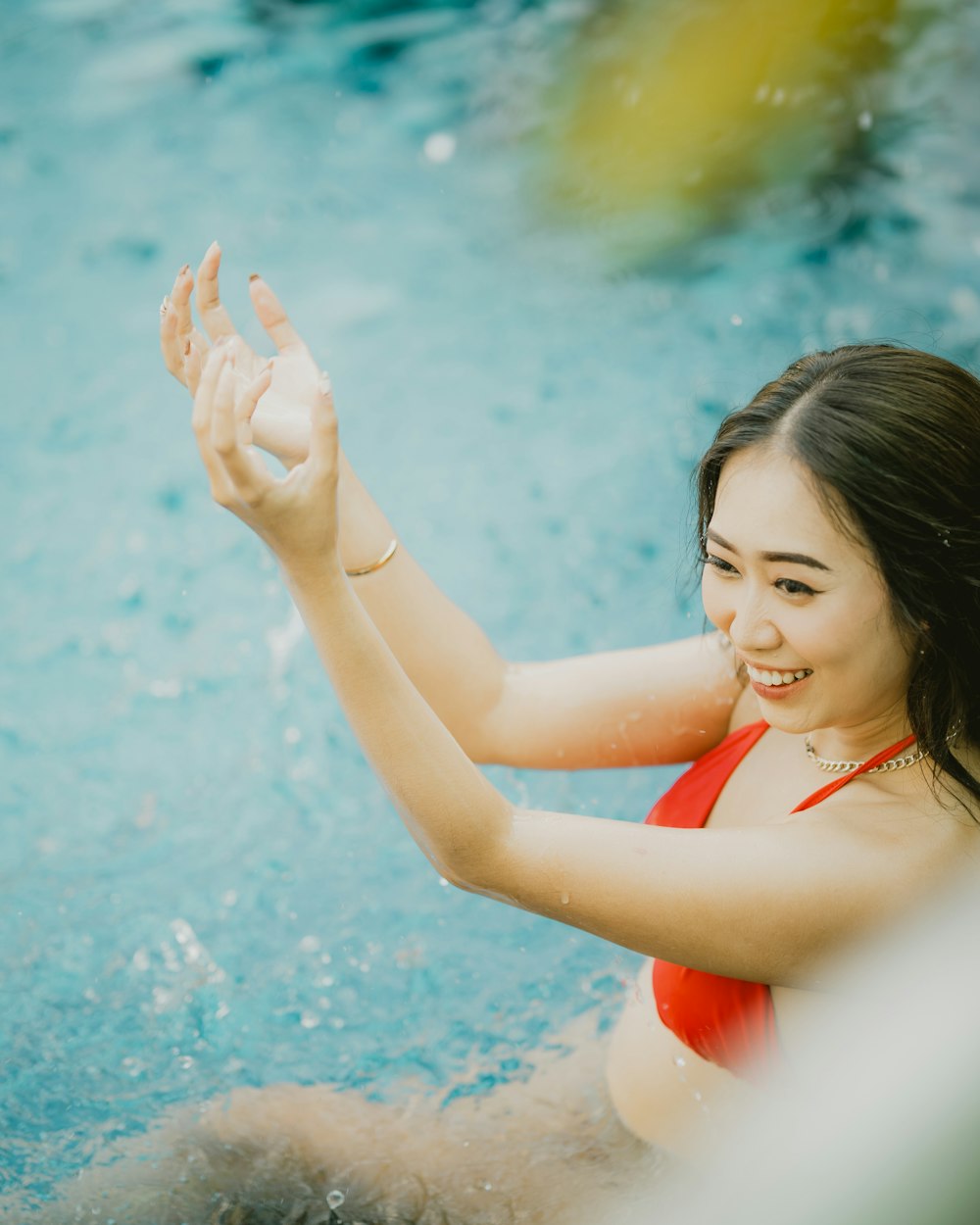 a woman in a red bathing suit in a pool