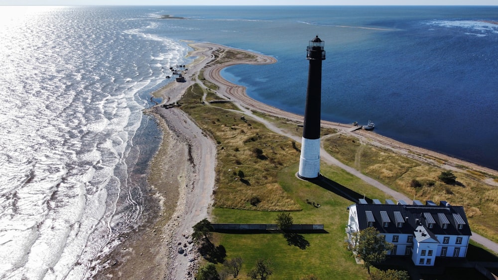 an aerial view of a lighthouse near the ocean