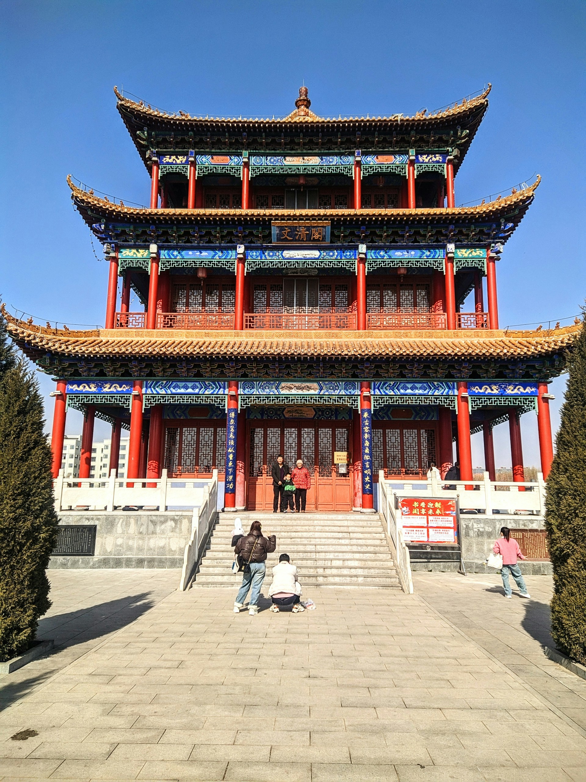 two people are standing in front of a building
