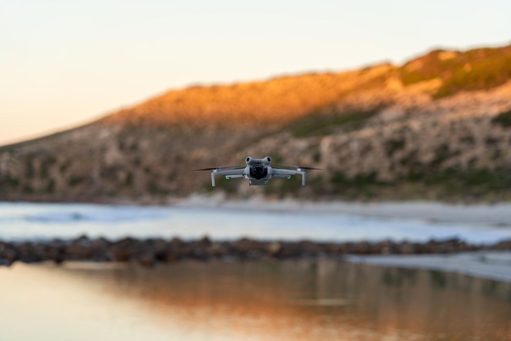 a small plane flying over a body of water