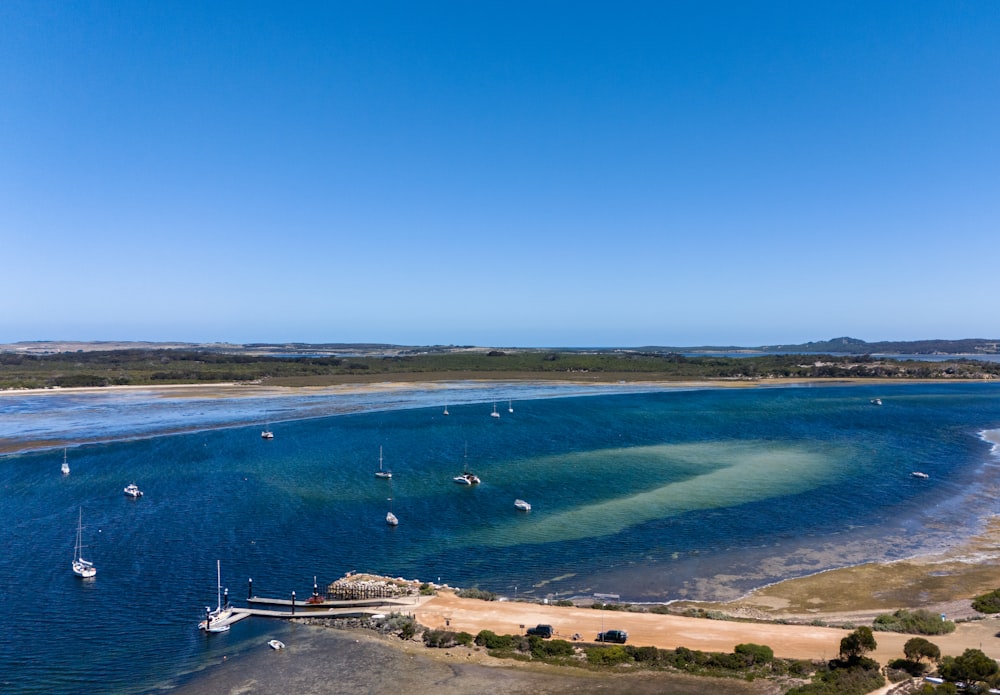 a large body of water surrounded by a sandy beach