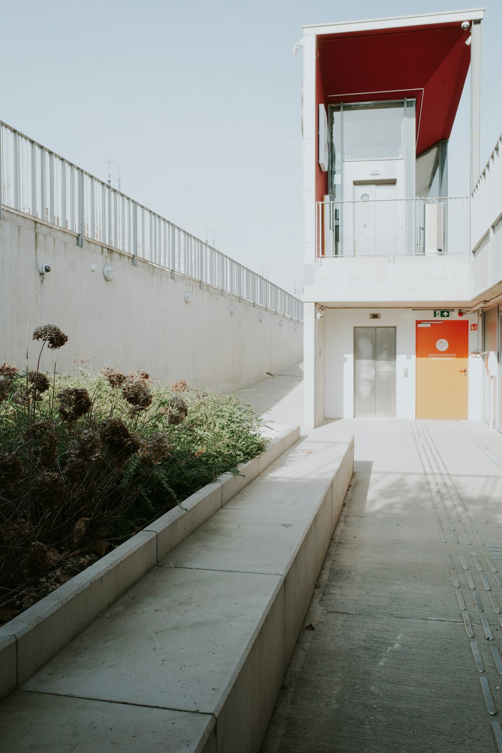 a white building with a red door and stairs