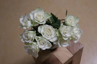a vase filled with white flowers on top of a table