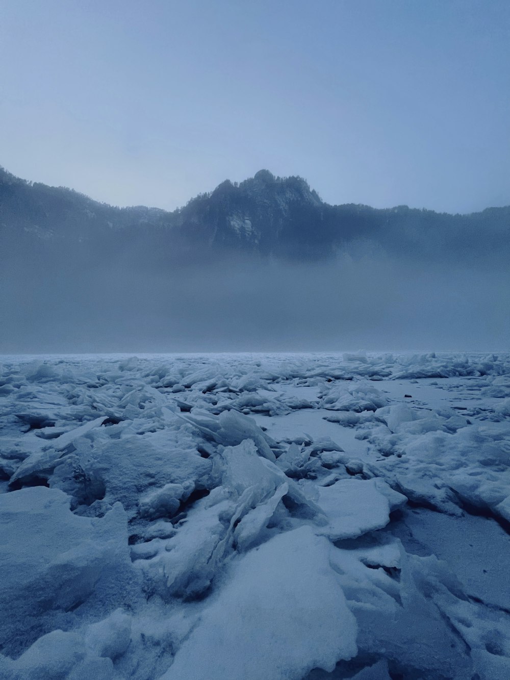 a view of a mountain range covered in snow