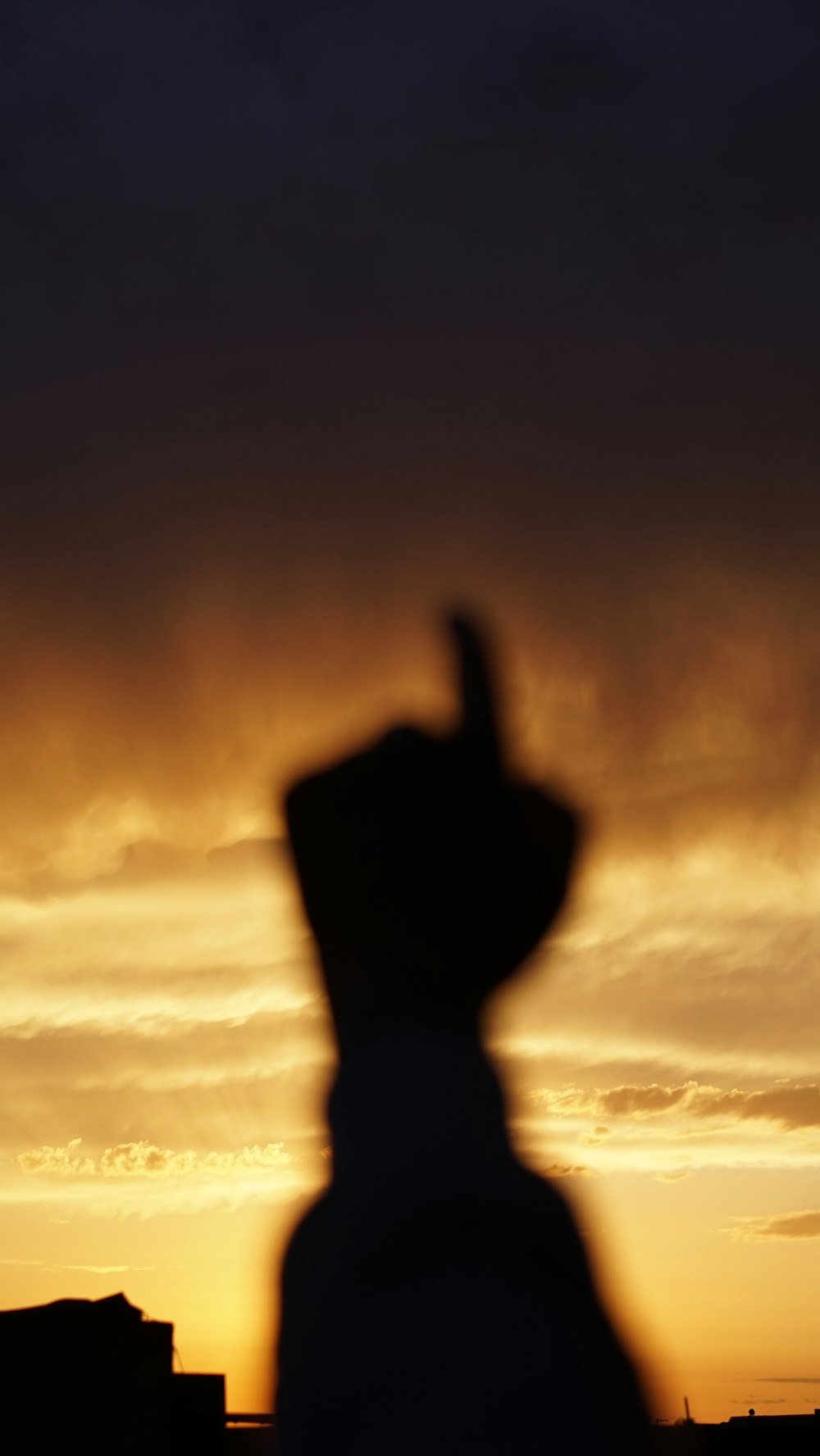 a silhouette of a person in front of a sunset