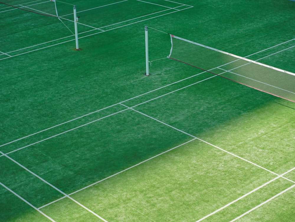 a tennis court with a net on the grass