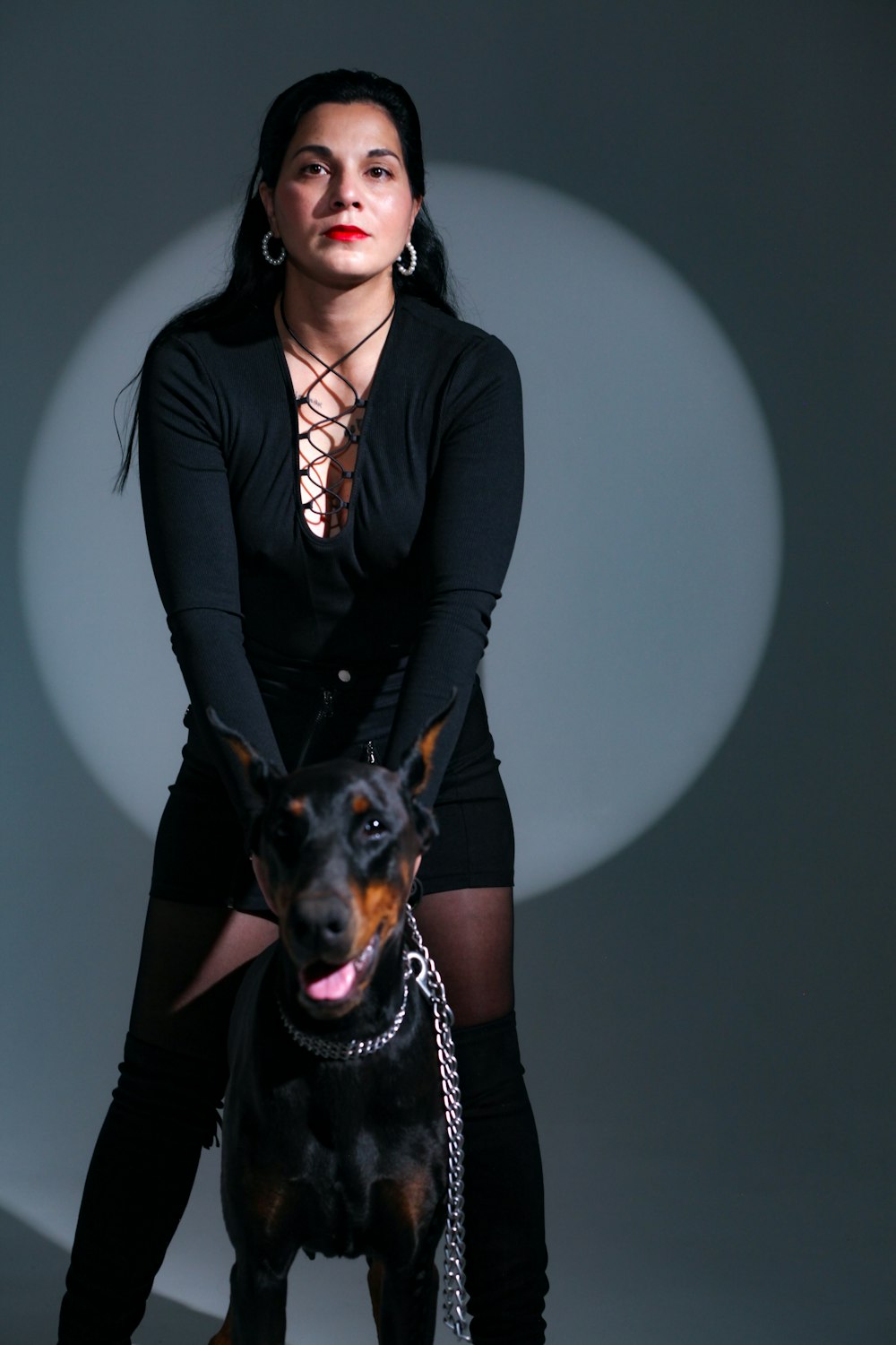 a woman posing with a dog on a leash