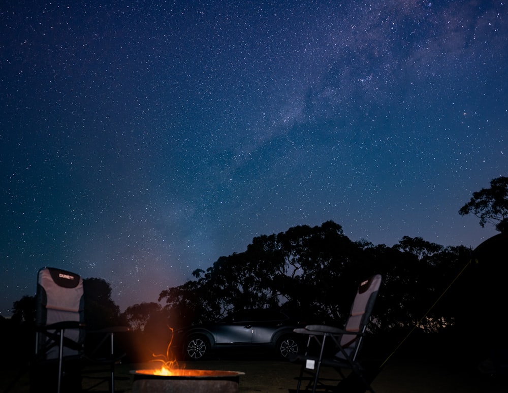 a couple of chairs sitting next to a fire pit