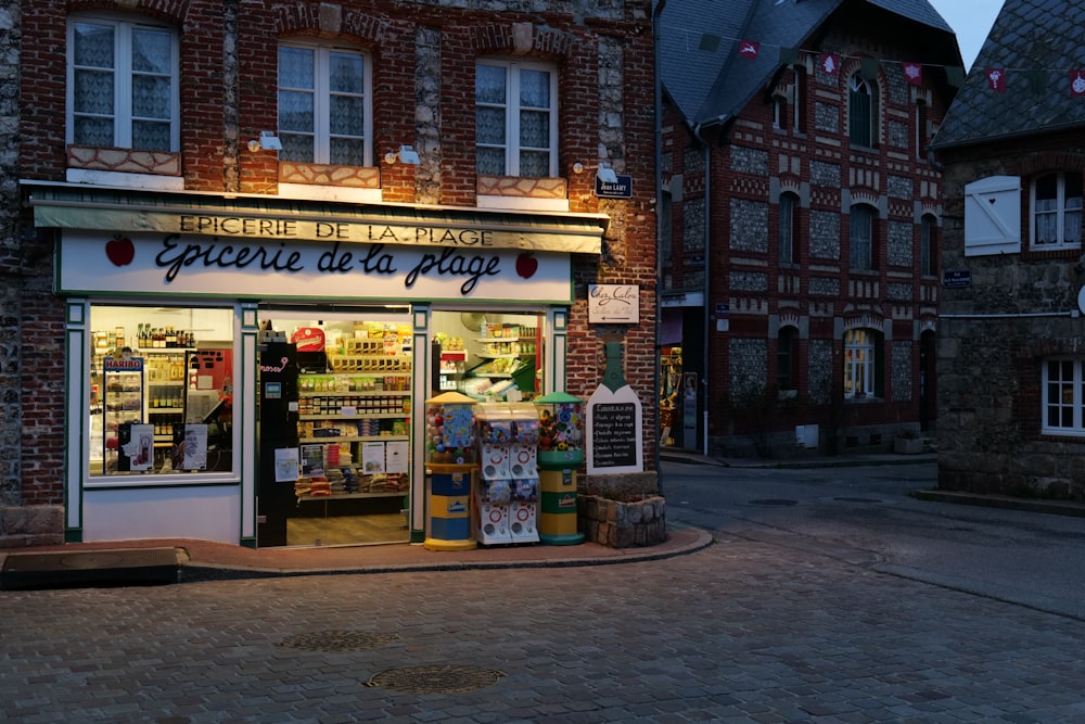 a street corner with a grocery store lit up at night