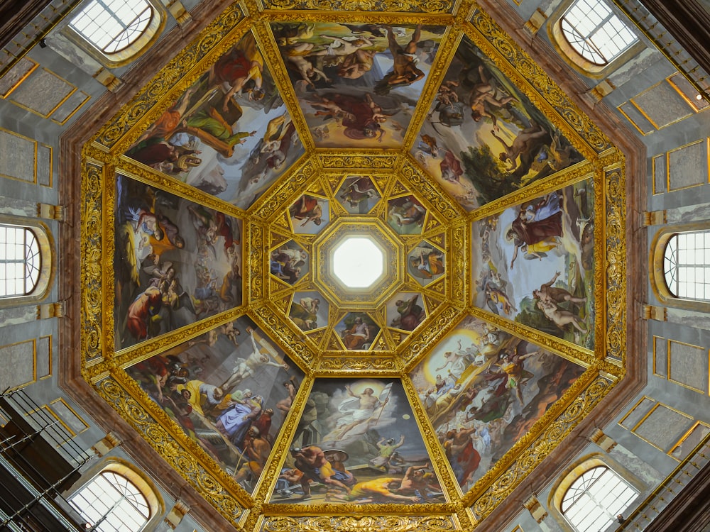 the ceiling of a building with paintings on it