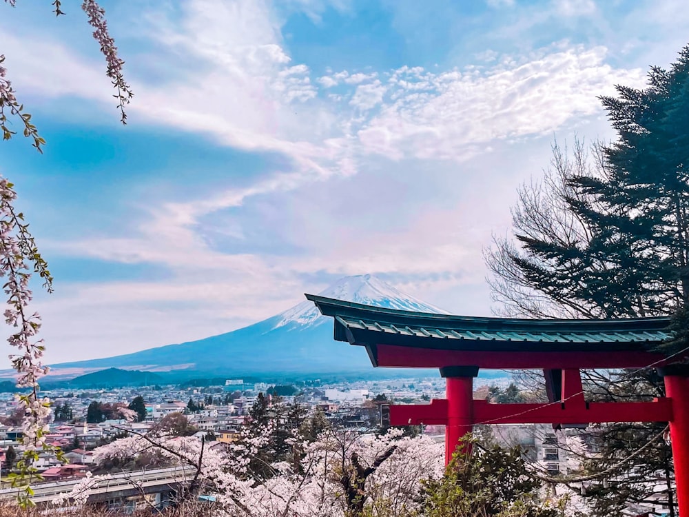 a red pagoda with a mountain in the background