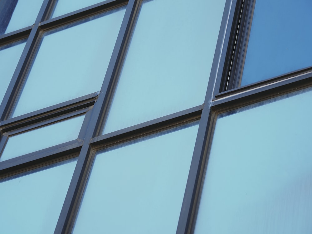 a close up of a building's windows with blue sky in the background