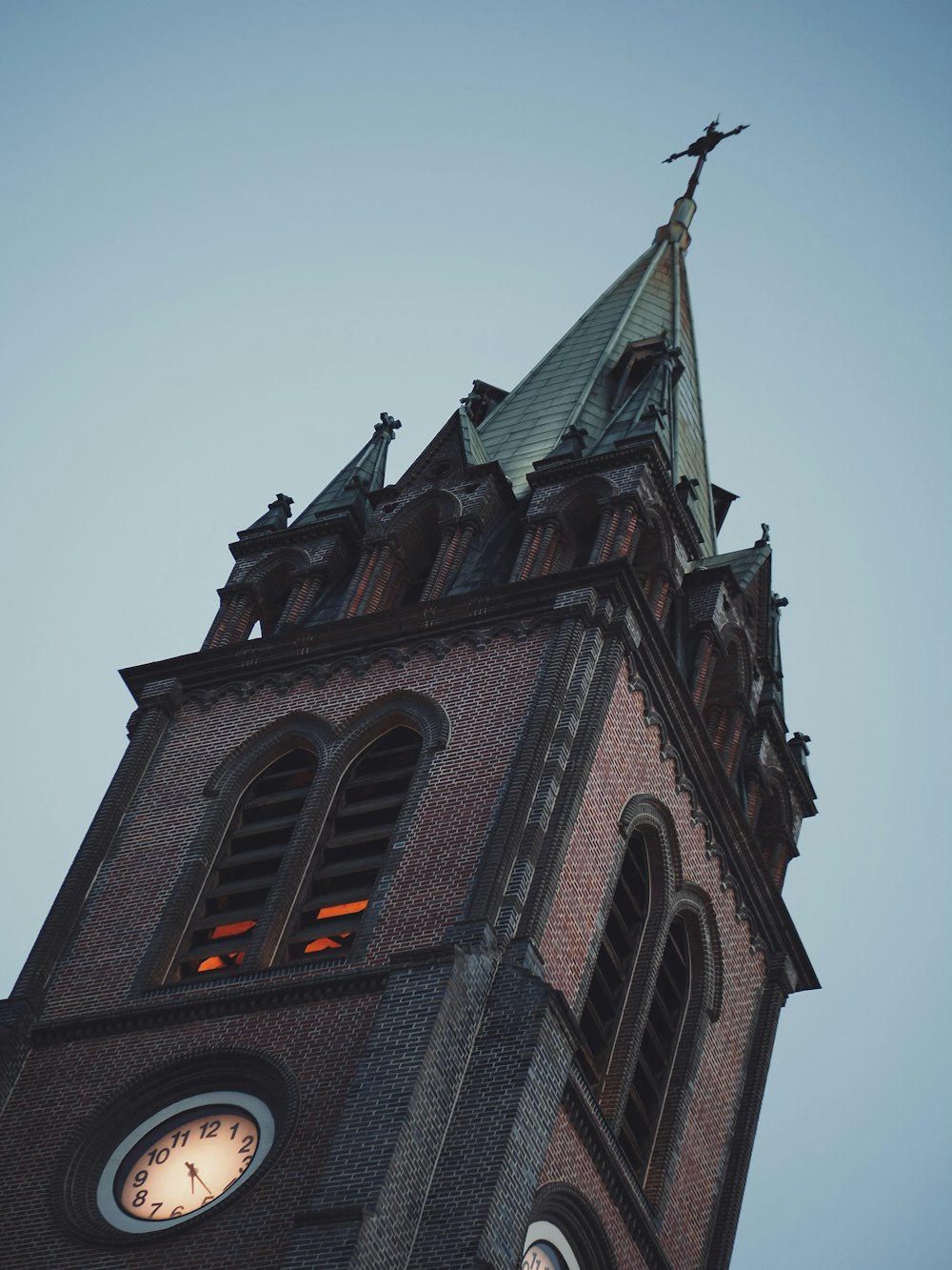 a tall clock tower with a clock on each of it's sides