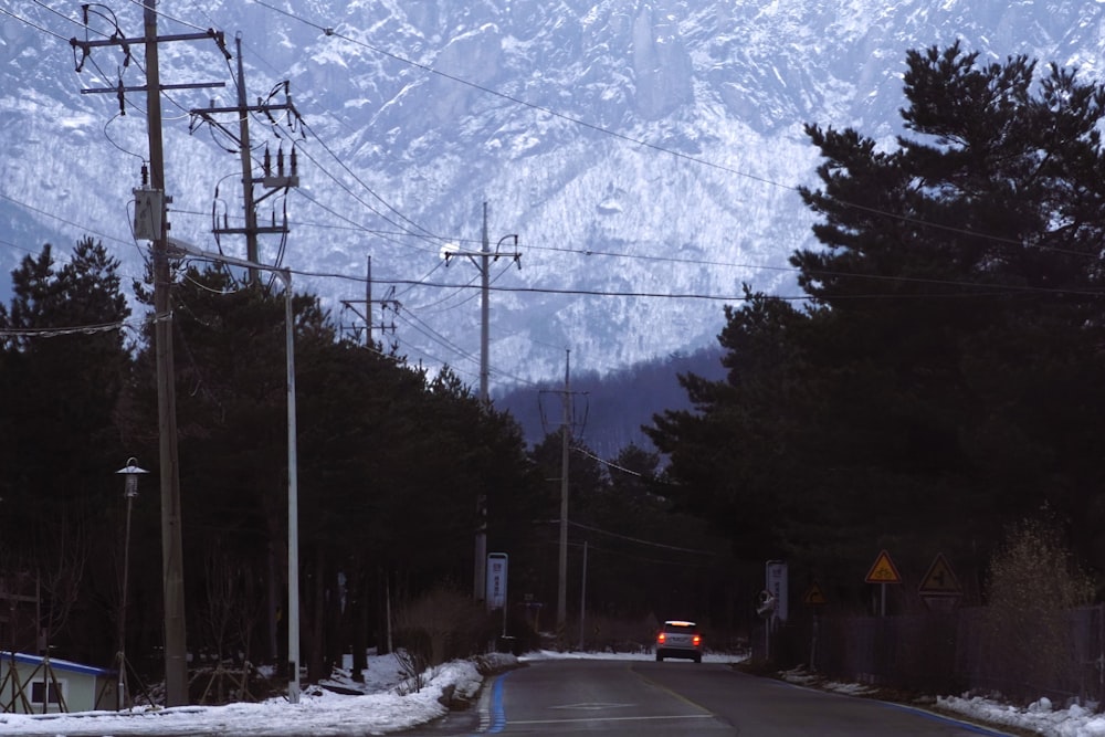 a car is driving down a snowy road