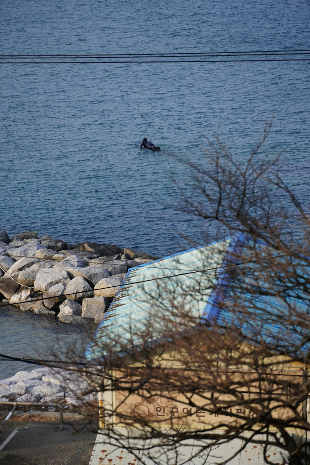 a man riding a surfboard on top of a body of water