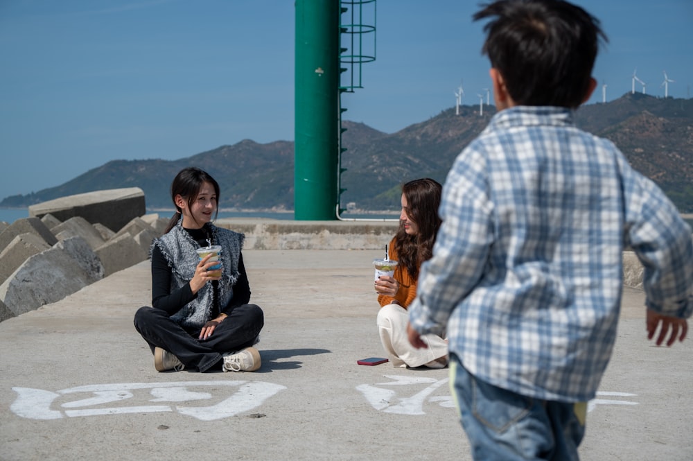 a group of young people sitting on the ground