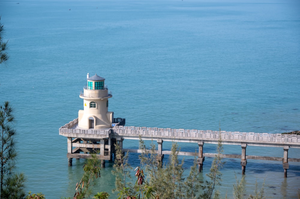 a light house sitting on top of a pier