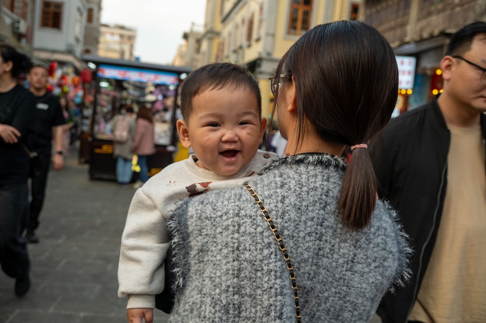 a woman holding a baby in her arms